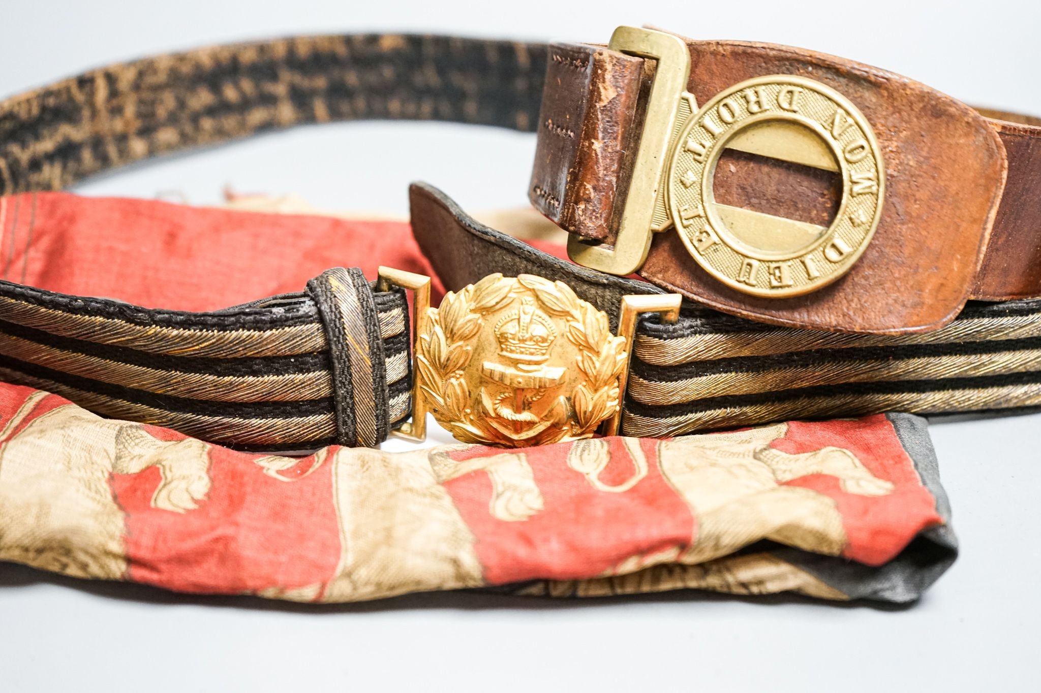 A Royal Naval gilt brass mounted officers belt and an Edwardian Dieu et mon droit belt and a Victorian printed flag